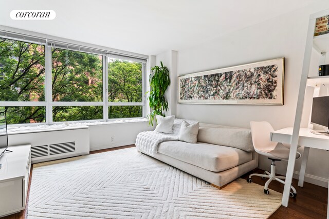 200 E 94th St Unit 405, New York City, NY 10128 - living room featuring healthy amount of natural light, wood finished floors, and an office area