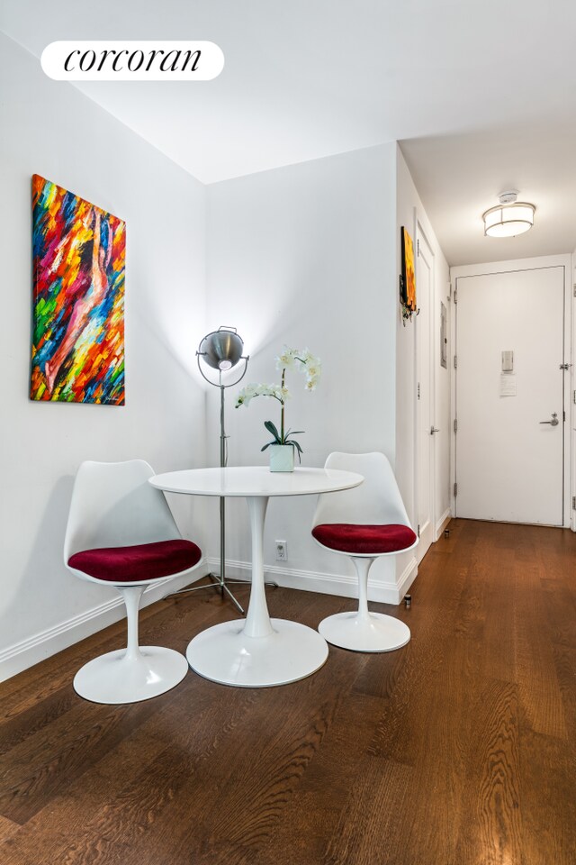 200 E 94th St Unit 405, New York City, NY 10128 - dining area featuring baseboards and wood finished floors