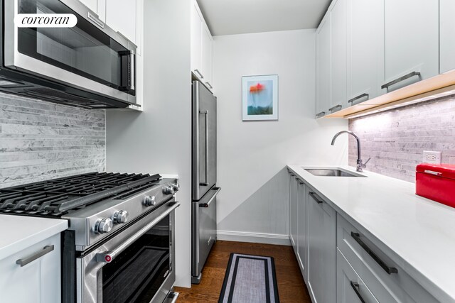 200 E 94th St Unit 405, New York City, NY 10128 - kitchen featuring high quality appliances, decorative backsplash, light countertops, and white cabinetry