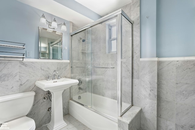 160 E 27th St Unit 11E, New York City, NY 10016 - full bathroom with tile walls, bath / shower combo with glass door, and marble finish flooring