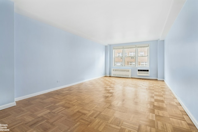 160 E 27th St Unit 11E, New York City, NY 10016 - empty room featuring radiator heating unit and a wall unit AC