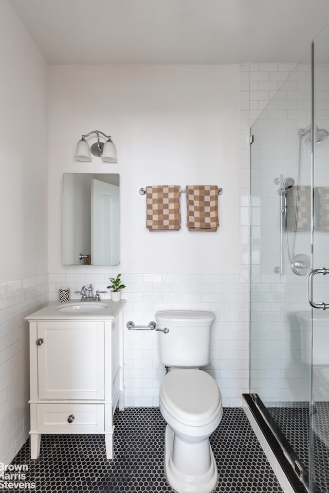 1148 Sterling Place, New York City, NY 11213 - full bath with tile walls, vanity, wainscoting, a stall shower, and tile patterned floors