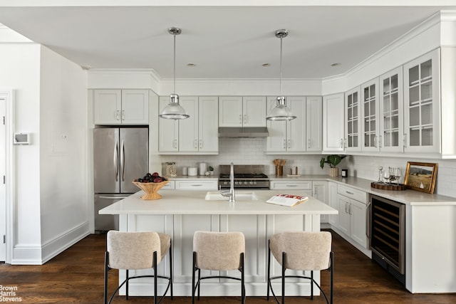 1148 Sterling Place, New York City, NY 11213 - kitchen featuring appliances with stainless steel finishes, under cabinet range hood, beverage cooler, a kitchen bar, and ornamental molding