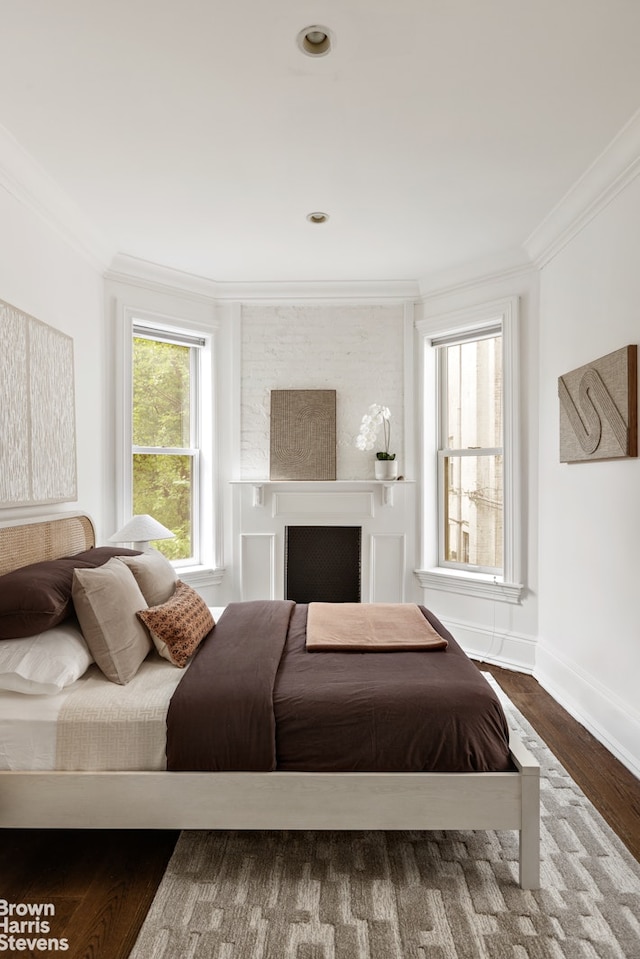 1148 Sterling Place, New York City, NY 11213 - bedroom with ornamental molding, wood finished floors, and a fireplace