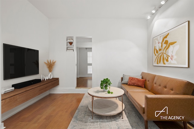 138 E 36th St Unit 1B, New York City, NY 10016 - living room with wood finished floors and rail lighting