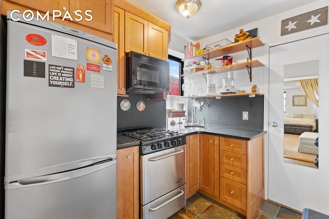 514 W 50th St Unit 5Rw, New York City, NY 10019 - kitchen with freestanding refrigerator, gas stove, black microwave, and dark countertops