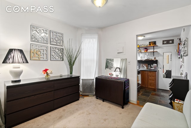 514 W 50th St Unit 5Rw, New York City, NY 10019 - bedroom featuring radiator heating unit and stone finish flooring