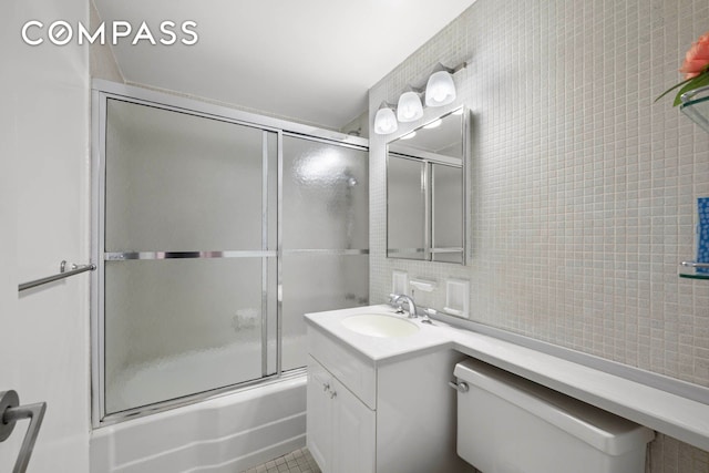 333 E 69th St Unit 3A, New York City, NY 10021 - full bathroom with vanity, combined bath / shower with glass door, tile walls, and decorative backsplash