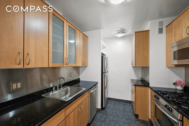 333 E 69th St Unit 3A, New York City, NY 10021 - kitchen featuring stainless steel appliances, glass insert cabinets, dark tile patterned flooring, and dark stone counters
