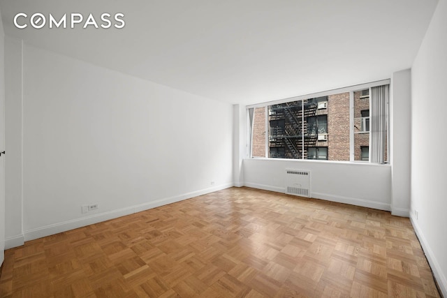 333 E 69th St Unit 3A, New York City, NY 10021 - empty room featuring radiator heating unit and baseboards