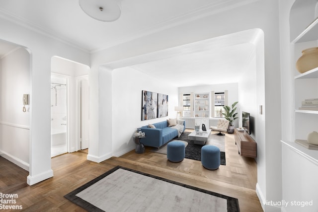 349 E 49th St Unit 6P, New York City, NY 10017 - living area with arched walkways, ornamental molding, and wood finished floors