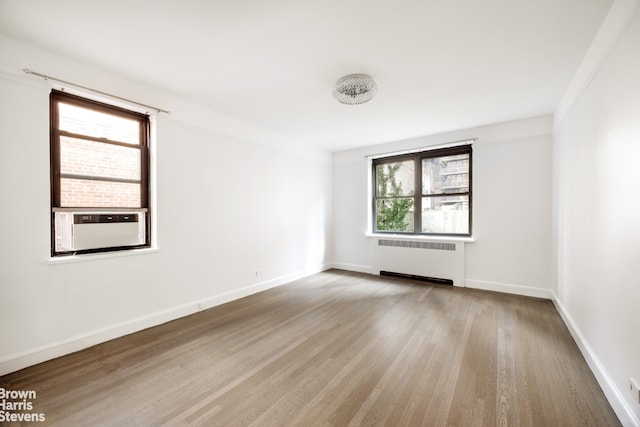 349 E 49th St Unit 6P, New York City, NY 10017 - unfurnished room featuring radiator heating unit and wood finished floors