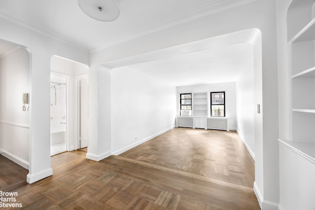 349 E 49th St Unit 6P, New York City, NY 10017 - unfurnished room with arched walkways, built in features, ornamental molding, and radiator