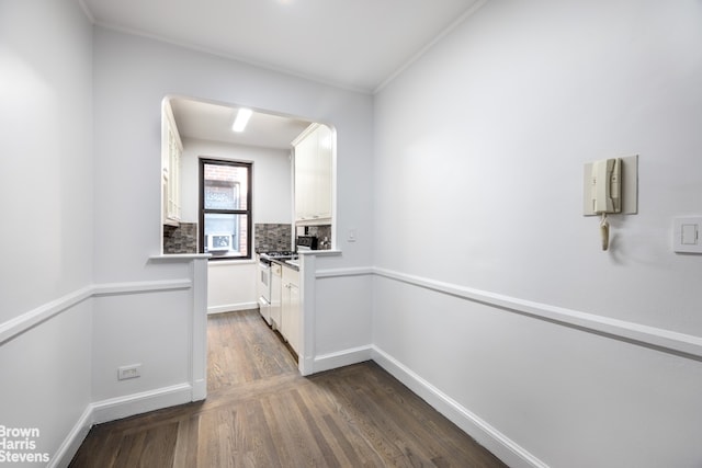 349 E 49th St Unit 6P, New York City, NY 10017 - corridor featuring dark wood-style flooring, arched walkways, and ornamental molding