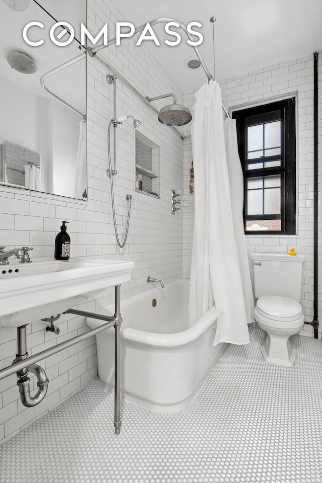 205 Hicks St Unit 2B, New York City, NY 11201 - bathroom with tile walls, shower / tub combo with curtain, and tile patterned flooring