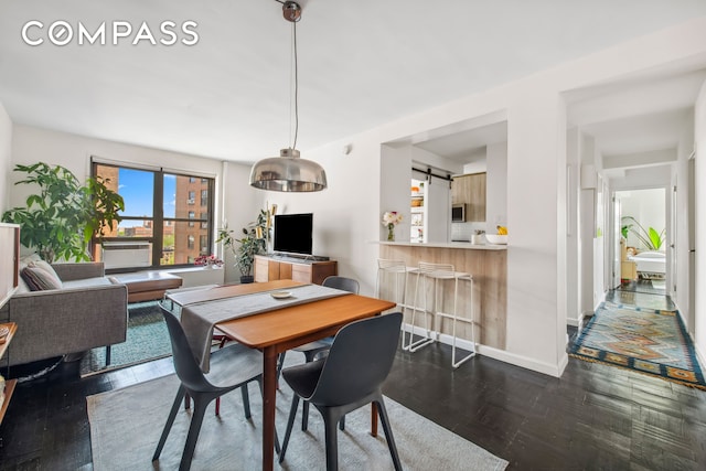 201 Clinton Ave Unit 10F, New York City, NY 11205 - dining room with baseboards and dark wood-style flooring