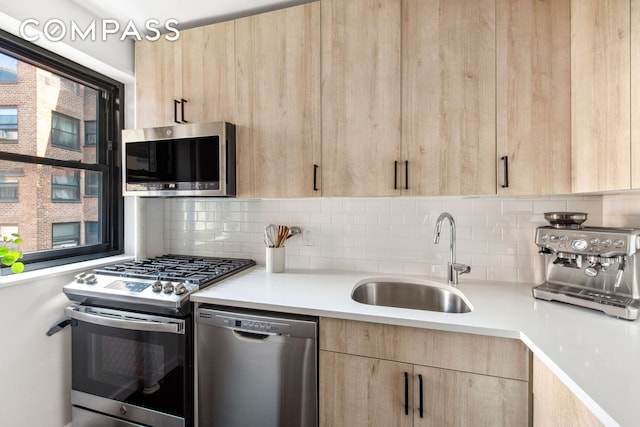 201 Clinton Ave Unit 10F, New York City, NY 11205 - kitchen with appliances with stainless steel finishes, light brown cabinets, light countertops, and backsplash