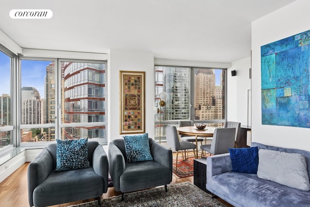 30 Little W St Unit 24A, New York City, NY 10004 - living area featuring wood finished floors and a skyline view