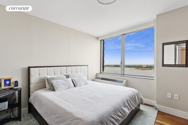 30 Little W St Unit 24A, New York City, NY 10004 - bedroom featuring wood finished floors and an AC wall unit