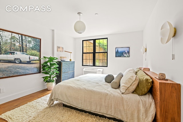 120 Pulaski St Unit 1B, New York City, NY 11206 - bedroom with multiple windows, wood finished floors, and an AC wall unit