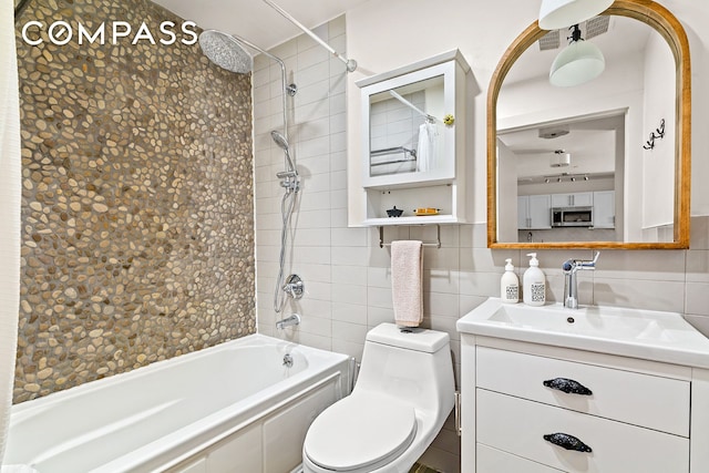 120 Pulaski St Unit 1B, New York City, NY 11206 - bathroom featuring tile walls, vanity, and washtub / shower combination