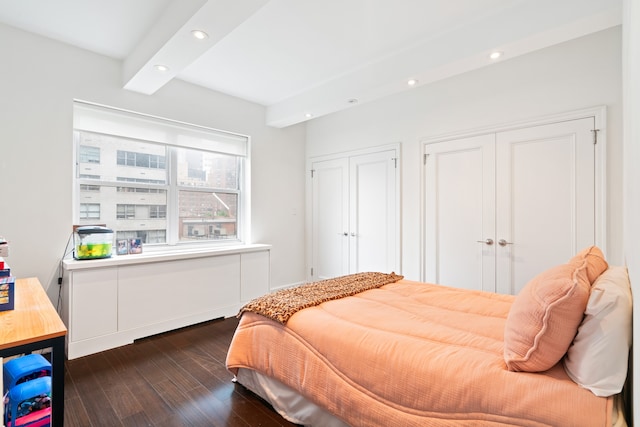 229 E 79th St Unit 7-B, New York City, NY 10075 - bedroom with dark wood-style floors, recessed lighting, and multiple closets