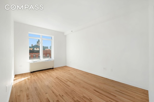 304 W 115th St Unit 6A, New York City, NY 10026 - unfurnished room with radiator and light wood-style floors