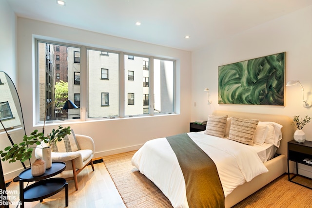 6 W 95th St, New York City, NY 10025 - bedroom featuring multiple windows, wood finished floors, and recessed lighting