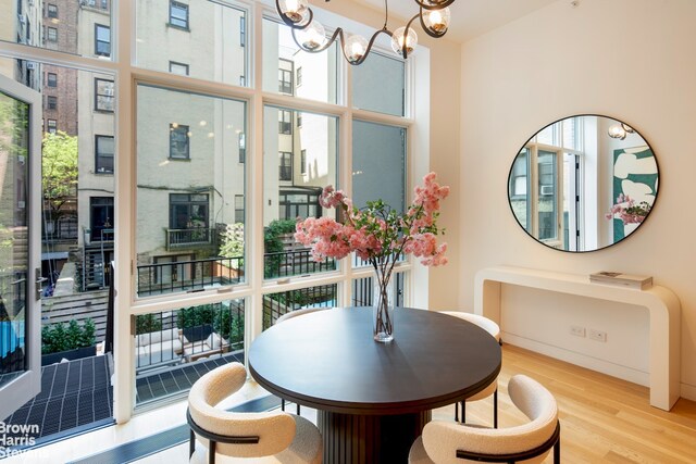 6 W 95th St, New York City, NY 10025 - dining space with plenty of natural light, wood finished floors, and a chandelier