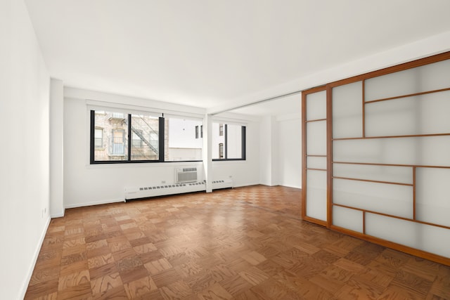 16 W 16th St Unit 7Rn, New York City, NY 10011 - empty room with a baseboard radiator and a wall mounted AC