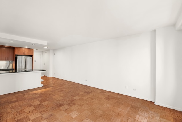 16 W 16th St Unit 7Rn, New York City, NY 10011 - unfurnished living room with recessed lighting and baseboards