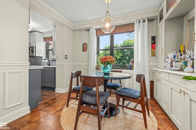 3103 Fairfield Ave Unit 4A, New York City, NY 10463 - dining space featuring a wainscoted wall, ornamental molding, and a decorative wall