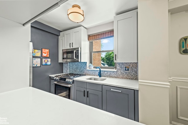 3103 Fairfield Ave Unit 4A, New York City, NY 10463 - kitchen featuring stainless steel appliances, decorative backsplash, light countertops, and white cabinets