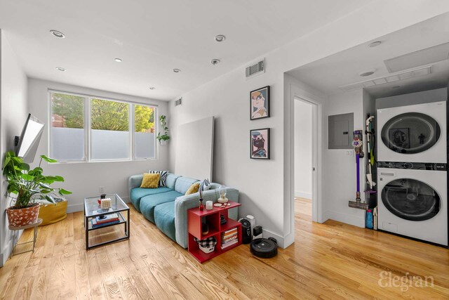 725 Lafayette Ave Unit 1A, New York City, NY 11221 - living room with stacked washing machine and dryer, electric panel, wood finished floors, and recessed lighting
