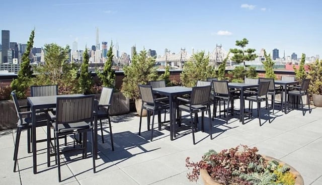 21-45 44th Dr Unit 4-C, New York City, NY 11101 - view of patio / terrace with outdoor dining space and a view of skyline