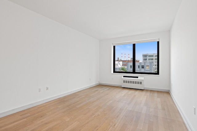 21-45 44th Dr Unit 4-C, New York City, NY 11101 - empty room featuring light wood-type flooring and radiator heating unit
