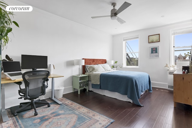 140 E 2nd St Unit 5T, New York City, NY 11218 - bedroom featuring radiator, multiple windows, wood finished floors, a desk, and ornamental molding