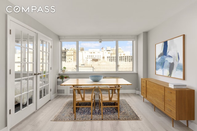 333 E 14th St Unit 11A, New York City, NY 10003 - dining area featuring light wood finished floors and french doors