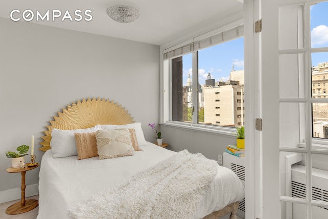 333 E 14th St Unit 11A, New York City, NY 10003 - bedroom featuring a city view and baseboards