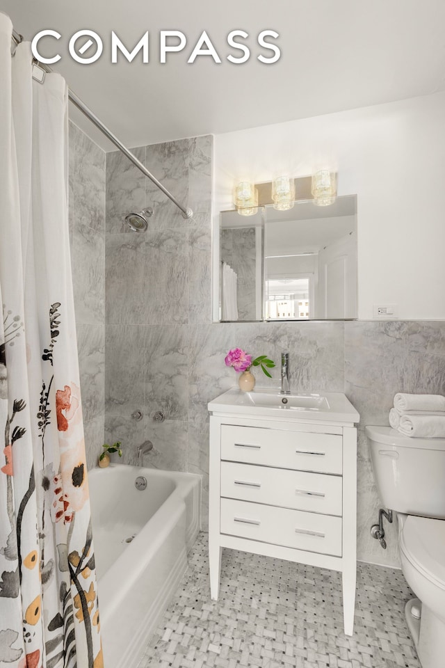 333 E 14th St Unit 11A, New York City, NY 10003 - bathroom with tile walls, shower / bath combo with shower curtain, and vanity