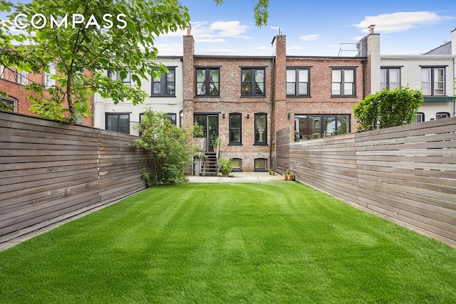 125 Rutland Rd, New York City, NY 11225 - back of property with a fenced backyard and brick siding