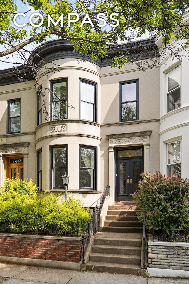 125 Rutland Rd, New York City, NY 11225 - view of front facade with french doors and stucco siding