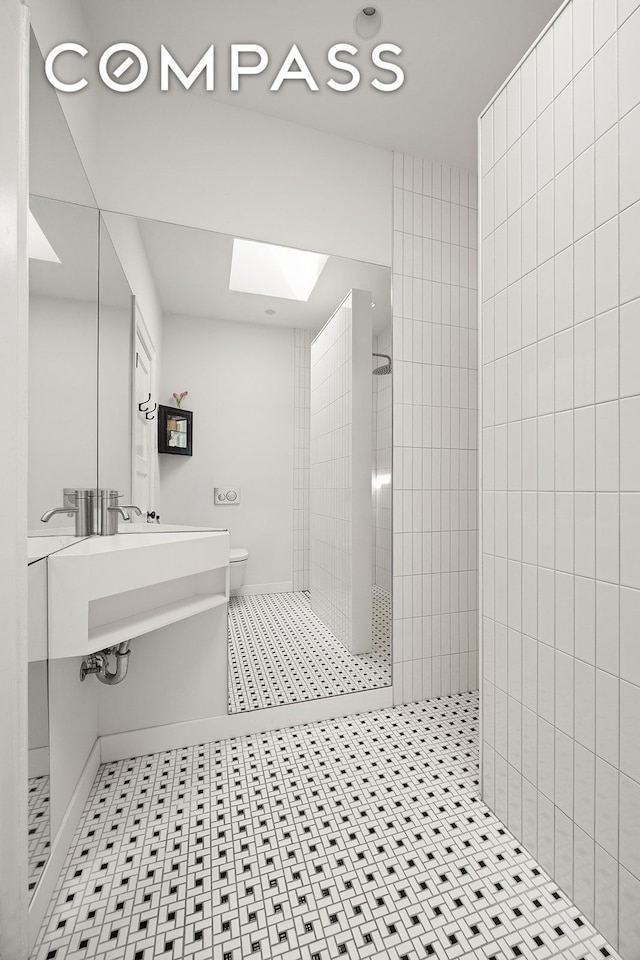 125 Rutland Rd, New York City, NY 11225 - full bathroom with walk in shower, a skylight, tile patterned floors, and recessed lighting