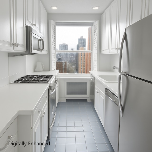 215 E 79th St Unit 12B, New York City, NY 10075 - kitchen featuring appliances with stainless steel finishes, white cabinetry, light countertops, light tile patterned floors, and recessed lighting
