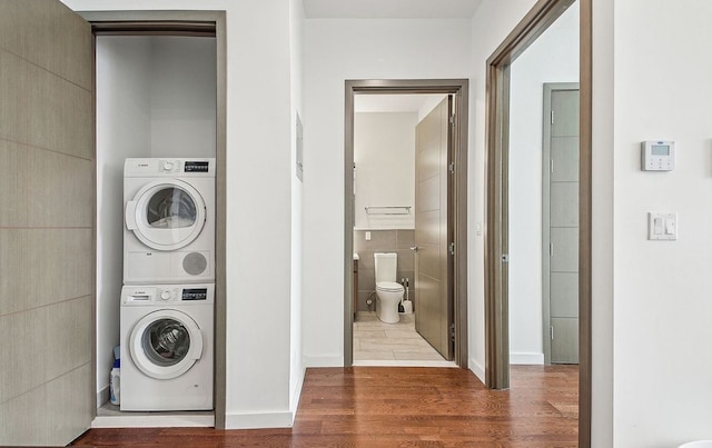 27-17 42nd Rd Unit 14-B, New York City, NY 11101 - laundry area with estacked washer and dryer and wood finished floors