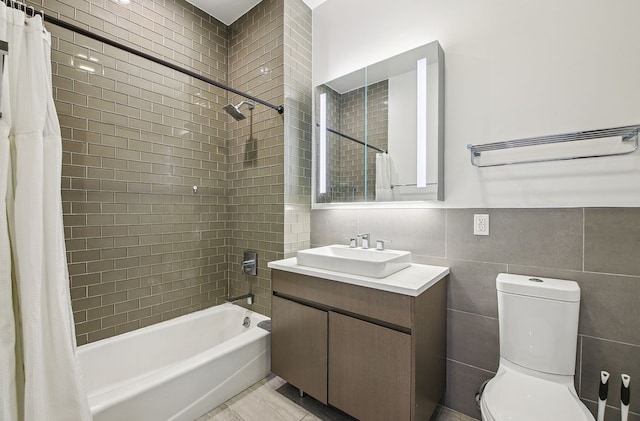 27-17 42nd Rd Unit 14-B, New York City, NY 11101 - bathroom featuring tile walls, vanity, and shower / bath combo