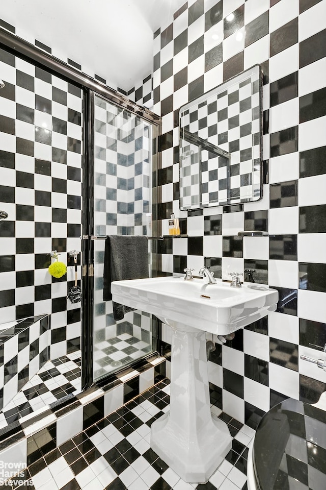 59 W 71st St Unit 4A, New York City, NY 10023 - bathroom featuring a stall shower, tile walls, and decorative backsplash
