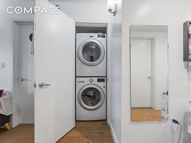 557 Hart St Unit 3A, New York City, NY 11221 - washroom featuring stacked washer and clothes dryer and wood finished floors