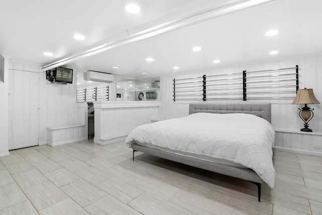 100-15 Ascan Ave, New York City, NY 11375 - bedroom featuring a wall mounted AC, recessed lighting, a decorative wall, and bar
