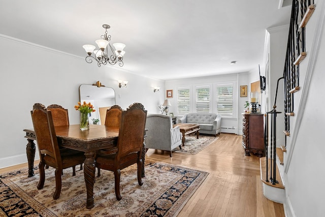 100-15 Ascan Ave, New York City, NY 11375 - dining space with a chandelier, a baseboard heating unit, stairs, light wood-type flooring, and crown molding